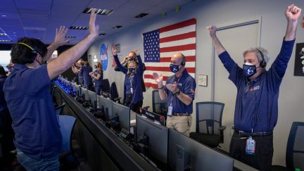 PASADENA, CA - FEBRUARY 18: In this handout image provided by NASA, members of NASA's Perseverance rover team react in mission control after receiving confirmation the spacecraft successfully touched down on Mars, , February 18, 2021 at NASA's Jet Propulsion Laboratory in Pasadena, California. A key objective for Perseverance's mission on Mars is astrobiology, including the search for signs of ancient microbial life. The rover will characterize the planet's geology and past climate, paving the way for human exploration of the Red Planet, and be the first mission to collect and cache Martian rock and regolith. (Photo by Bill Ingalls/NASA via Getty Images)