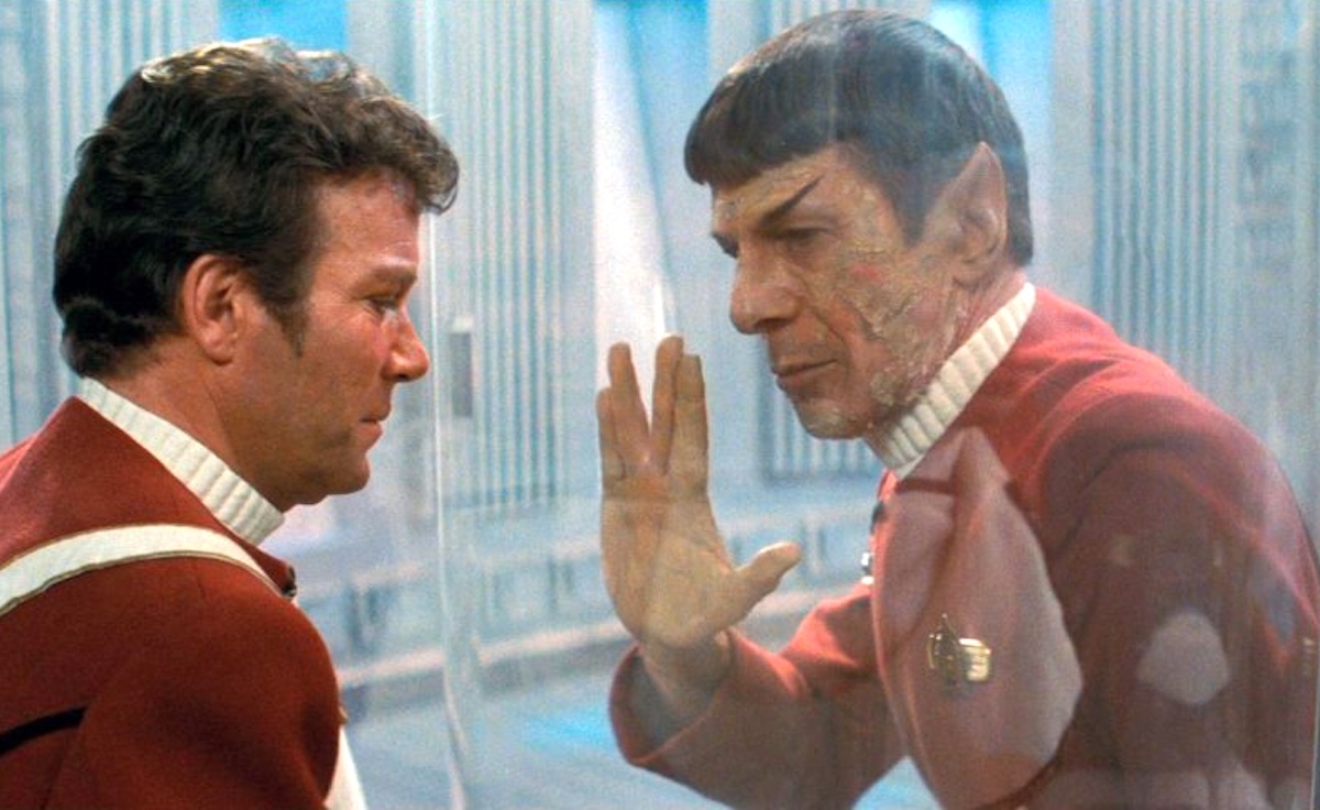 Kirk and Spock separated by glass and Spock gives him the vulcan salute in 'Wrath of Khan'