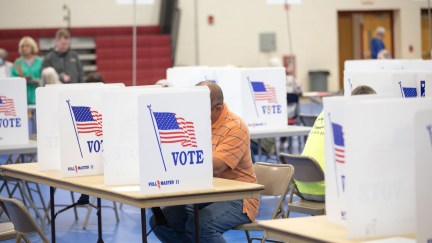 New Hampshire voter at center of a few voting booths